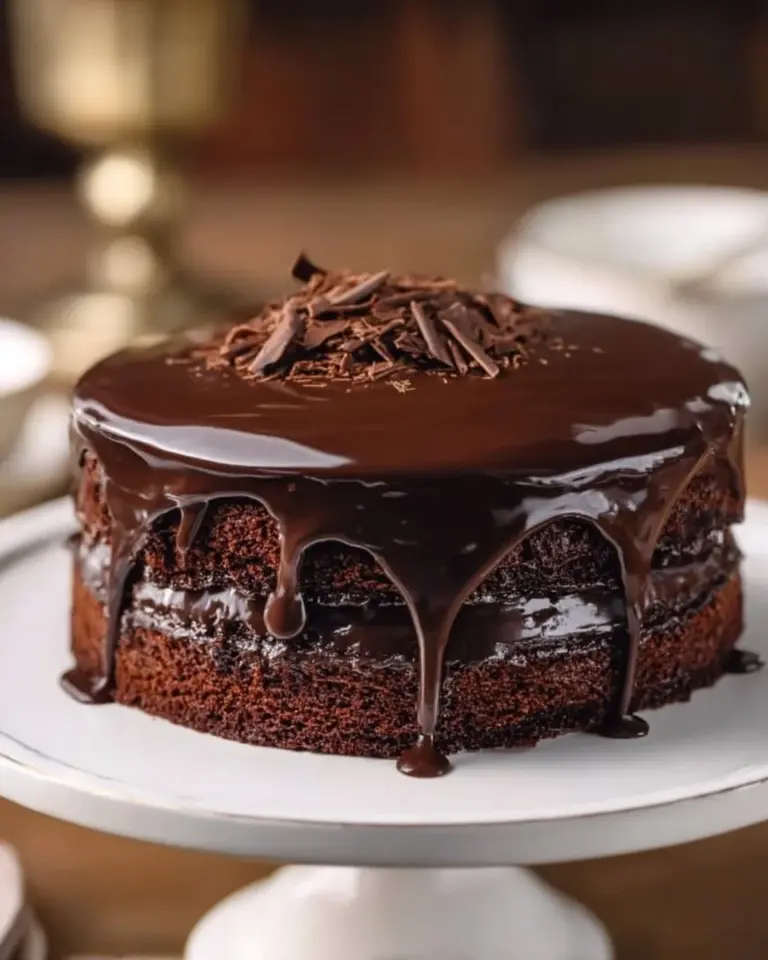 Delicious slice of chocolate sour cream cake topped with chocolate frosting