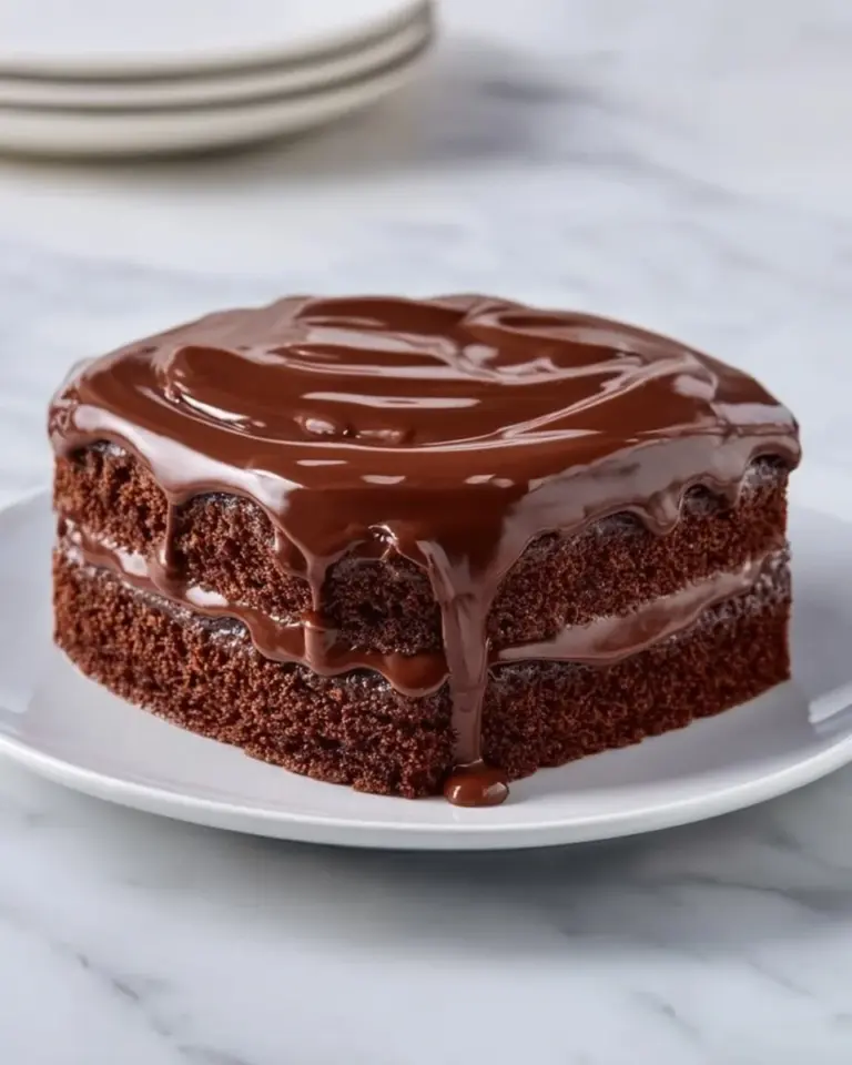Delicious Chocolate Three Milks Cake topped with chocolate frosting and berries.