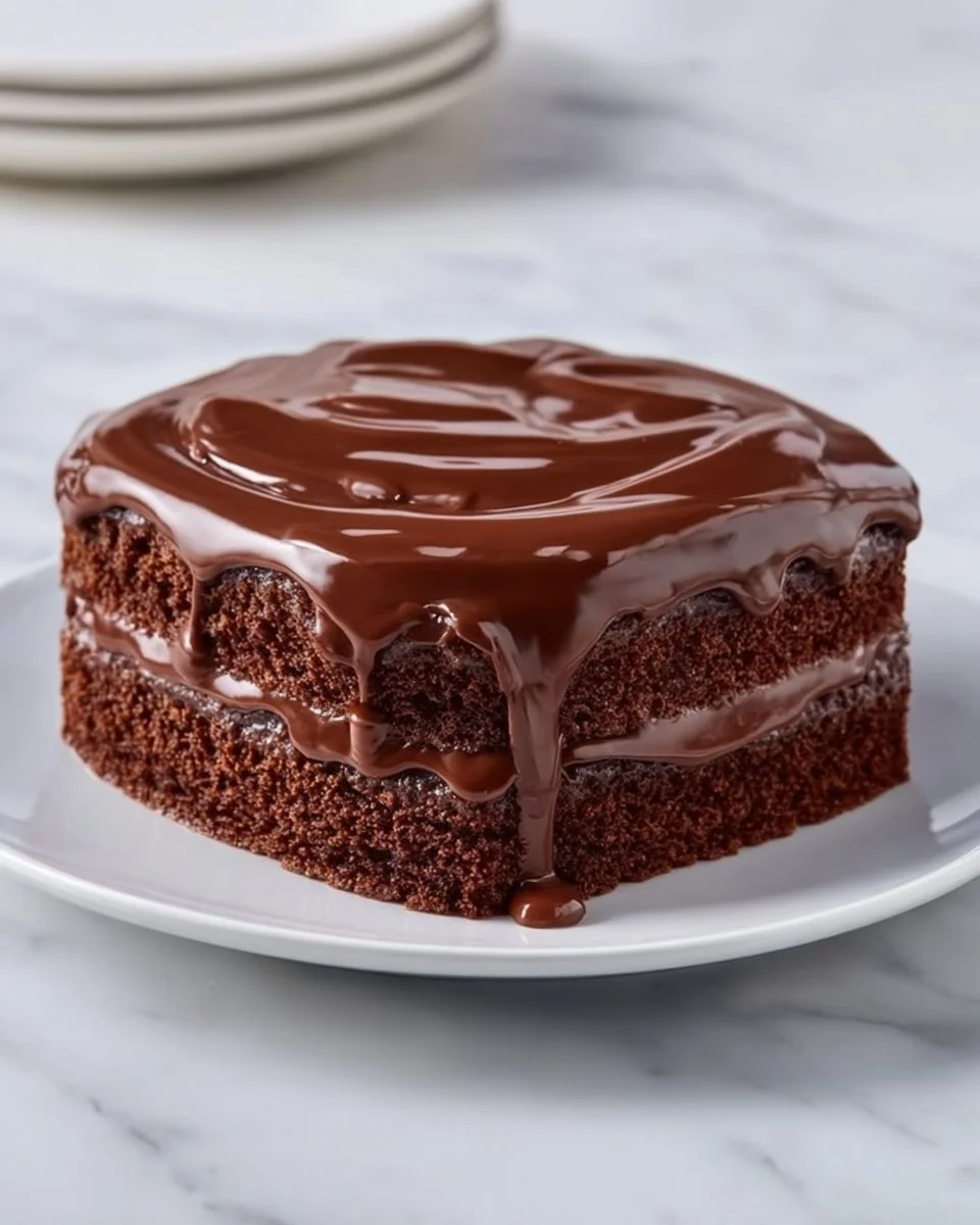 Delicious Chocolate Three Milks Cake topped with chocolate frosting and berries.