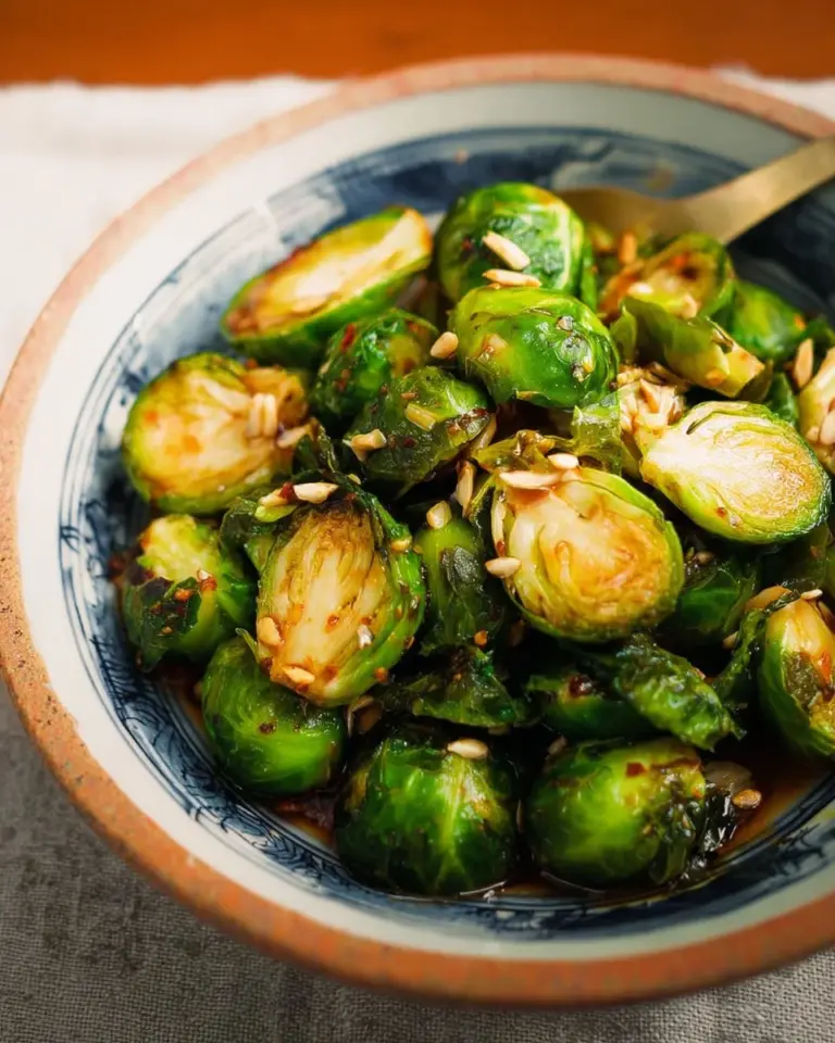 Maple Fish Sauce Brussels Sprouts on a plate garnished with herbs
