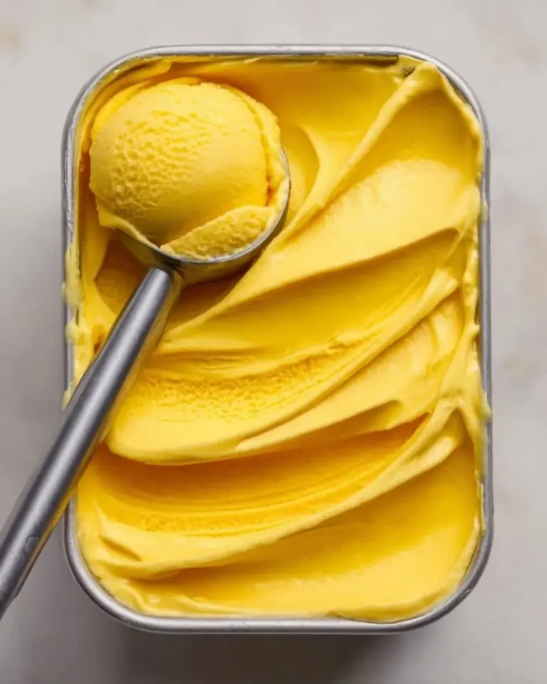 Delicious summer mango ice cream topped with fresh mango slices