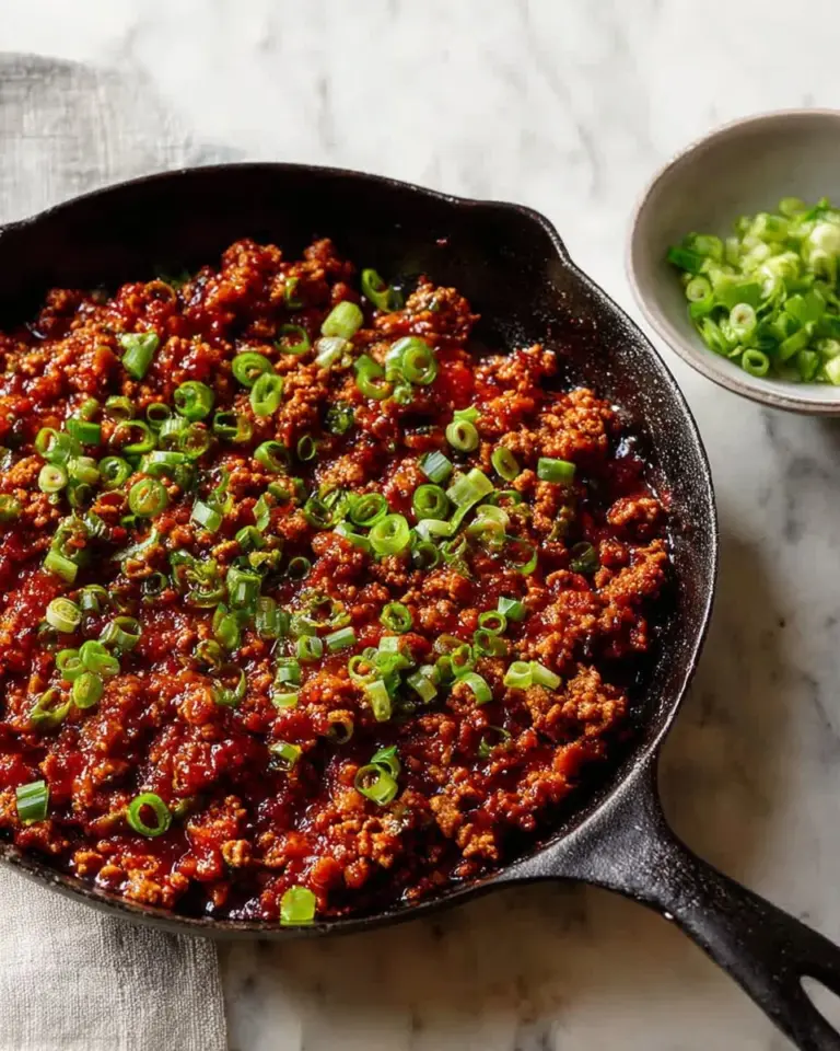 Savory ground turkey dish made with gochujang sauce garnished with fresh herbs
