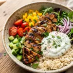 Delicious Chicken Shawarma Bowl topped with fresh vegetables and flavorful sauces.