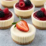 Delicious mini cheesecakes topped with fresh fruit and served on a plate.